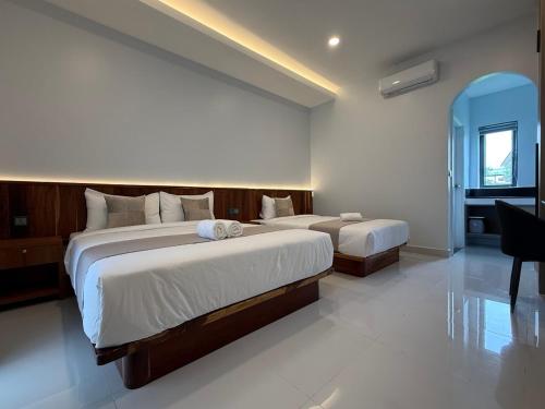 a bedroom with two beds and a desk in it at Family Motel in Bahal