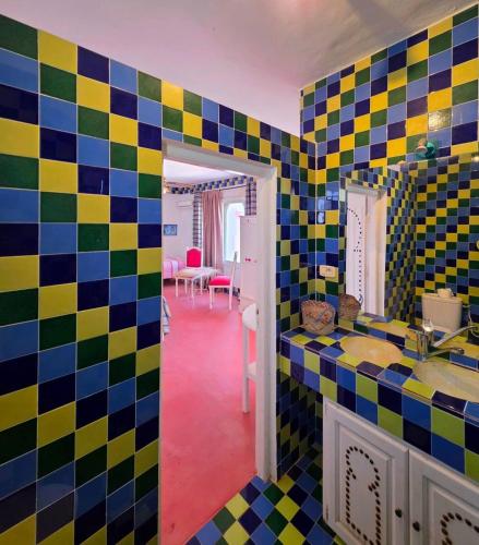 a bathroom with colorful tiles on the wall at Nanou in Zarzis