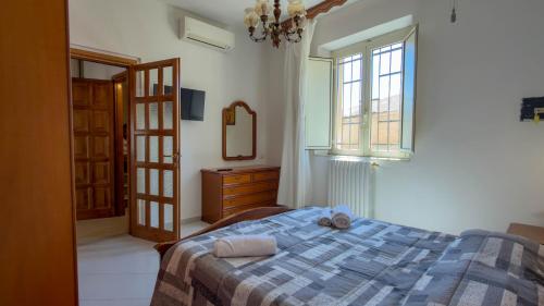 a bedroom with a bed and a dresser and a window at Casa Gala in Mamoiada