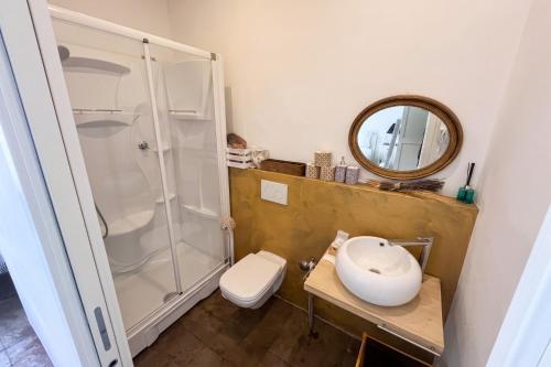 a bathroom with a shower and a toilet and a sink at Casa Porto Vecchio in Peschiera del Garda