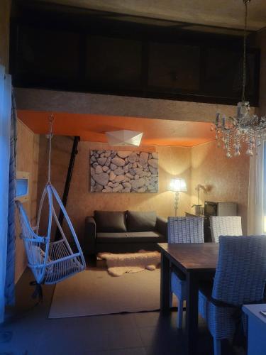 a living room with a couch and a table at Mini house Imatra with own garden in Imatra