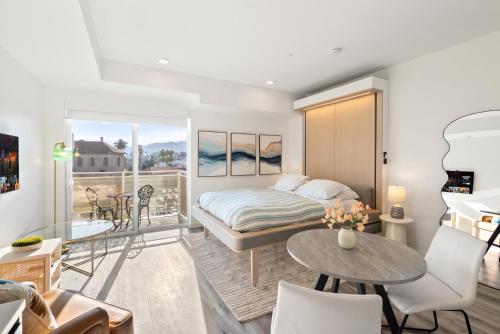 a bedroom with a bed and a balcony at Modern Hollywood Studio, Pool Parking Gym in Los Angeles