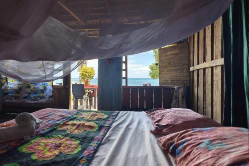 a bedroom with a bed with a view of the ocean at Perlas del cabo nuqui choco in Nuquí
