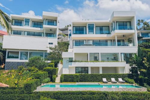 an apartment building with a swimming pool in front of it at AAA villa in Ban Bang Po
