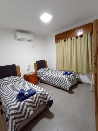 a room with two beds in a room at La Niña in Belén