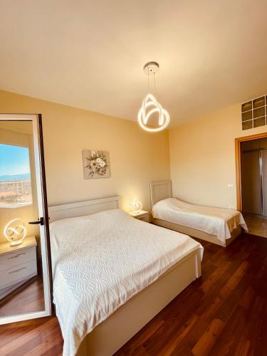 a bedroom with two beds and a window at Shkodra Central Corner in Shkodër
