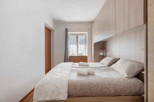 a bedroom with a large bed with two towels on it at Aphrodite's Garden in Gera Lario