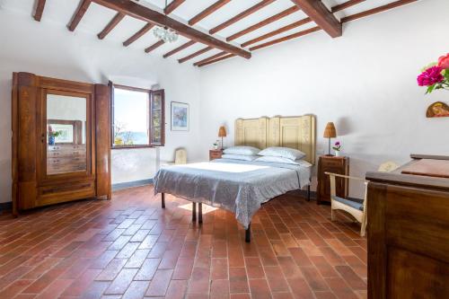 a bedroom with a bed and a table in it at Fattoria Poggerino in Radda in Chianti