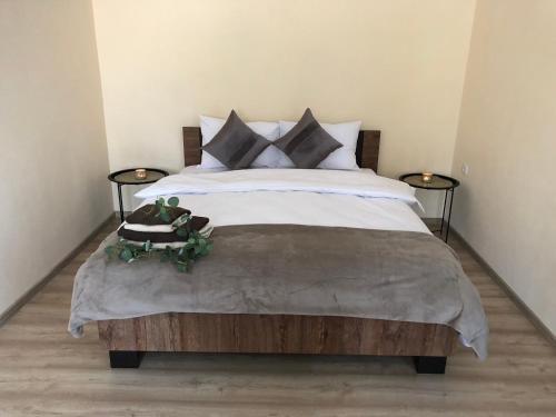 a bedroom with a large bed with two side tables at Light house in Ternopil