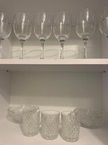 a row of wine glasses sitting on a shelf at Light house in Ternopil