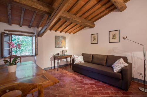 a living room with a couch and a table at Fattoria Poggerino in Radda in Chianti