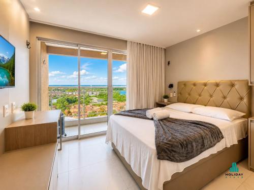 a bedroom with a large bed and a large window at Fortaleza Sul Prime By Holiday Stays in Fortaleza
