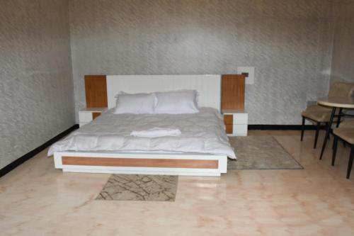 a large bed in a room with a table at Royal Palace Hotel Harar in Hārer
