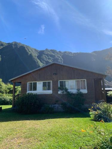 a house with a mountain in the background at Les Châlets du Medinilla in La Plaine des Palmistes
