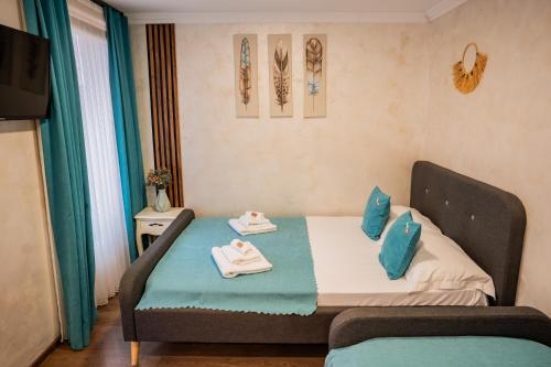 a small room with a bed with towels on it at Vama 22- Vama Veche in Vama Veche