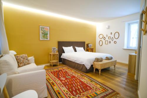 a bedroom with a bed and a couch at L'Upupa Bed & Breakfast in Muscoline