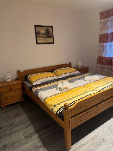 a bedroom with a wooden bed with yellow sheets at Wohlfühlwohnung Wiesenfeld in Wiesenfeld