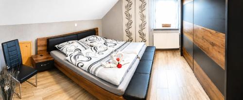 a bedroom with a bed with a black and white comforter at Ferienwohnung Frischkorn in Steinau an der Straße