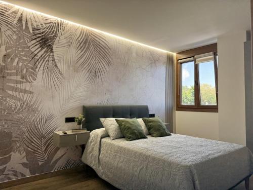 a bedroom with a bed with a wall mural at Flower Beach Helgueras 2 - 6092 in Noja
