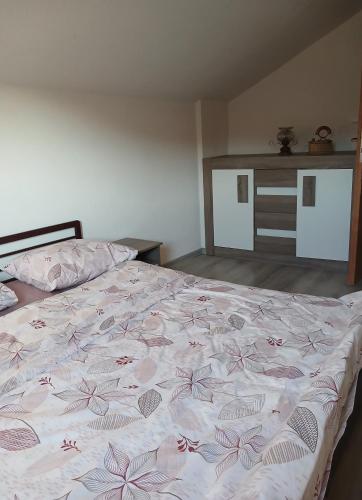 a bedroom with a bed with pink flowers on it at Idiličan brijeg in Višegrad