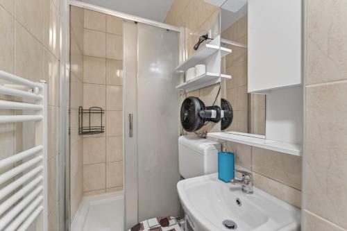 a bathroom with a toilet and a sink and a shower at Izba Vacation Home in Međugorje