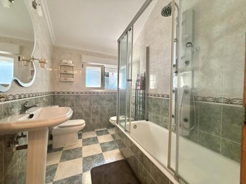 a bathroom with a sink toilet and a shower at Chalet Amarena 20812 in Argoños