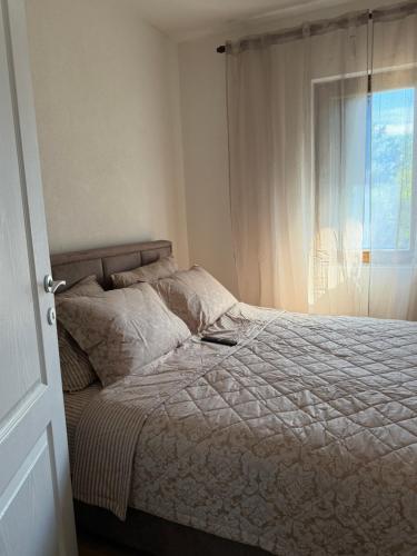 a bedroom with a large bed with a window at Tri topole Brioni in Kočino Selo