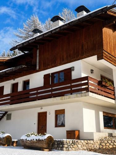 a building with a balcony on top of it at Chalet Capriol by My Villa Collection in Cortina dʼAmpezzo