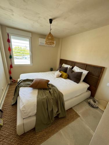 a bedroom with a large bed and a window at Playa del Ter in Platja de l'Arenal