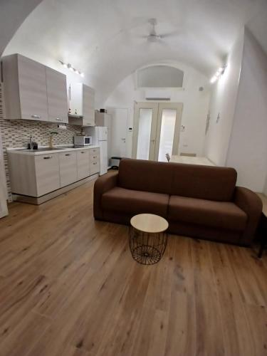 a living room with a brown couch and a table at CASA NiNì in Trani
