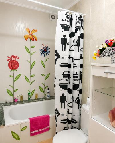 a bathroom with a black and white shower curtain at VILLA MIRAMAR in Peniscola