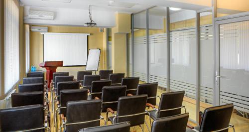 a lecture room with chairs and a whiteboard at Voyage Hotel in Almaty