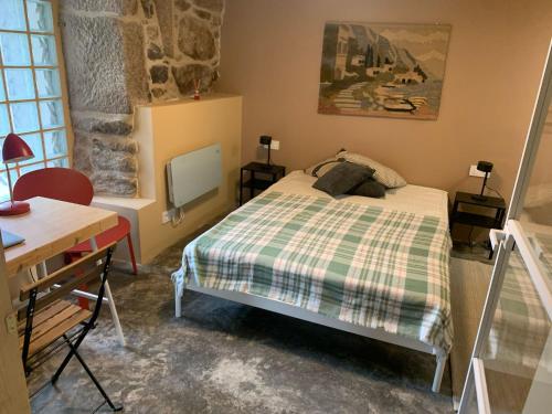 a bedroom with a bed and a desk and a mirror at Casa dos Carballos in Covelo