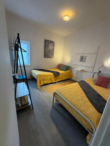 a room with two beds and a ladder in it at Quinta do Norte - Biscoitos in Biscoitos