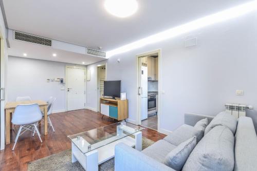 a living room with a couch and a table at The Corporate Residence & Parking in Madrid