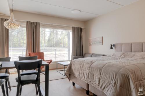 a bedroom with a bed and a table and chairs at Äkäsentie 1 A 211 by Holiday in Lapland in Äkäslompolo