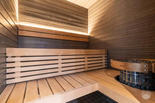 a sauna with wooden walls and a wooden floor at Äkäsentie 1 A 211 by Holiday in Lapland in Äkäslompolo