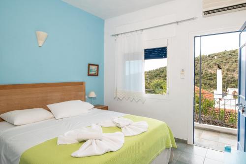a bedroom with a bed with two towels on it at Ikion Studios in Steni Vala Alonissos
