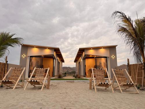 a group of chairs sitting in front of a house at El Rubio Beach Bungalows in Zorritos