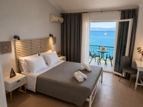 a bedroom with a bed with a view of the ocean at Aether seaview in Benitses