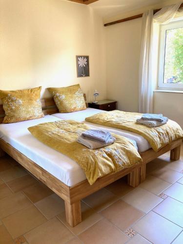 a bedroom with two beds and a window at Burgblick Pünderich in Pünderich