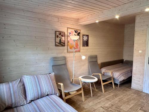 a room with two chairs and a bed and a table at Domek Dobrawa- 400m do morza in Międzyzdroje