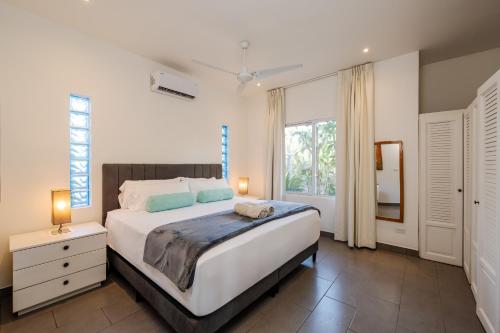 a bedroom with a large bed and a window at Pazifico Villas in Playa Avellana