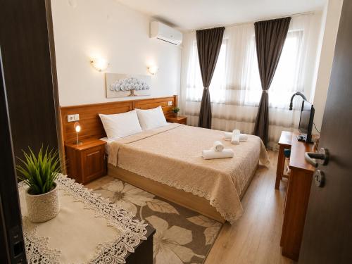 a bedroom with a bed with two towels on it at Diamond Heights apartament in Bansko