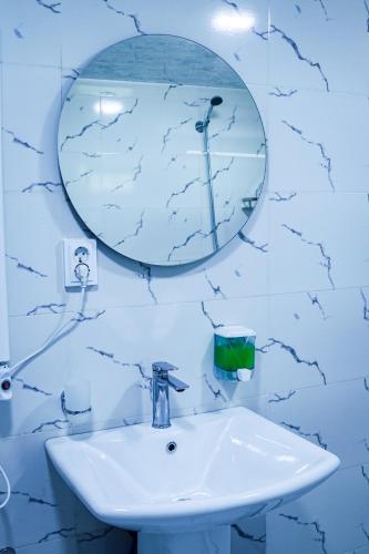 a bathroom with a sink and a mirror at Guest House Adelina in Mestia