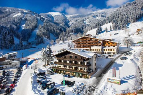 a snowy mountain with a ski lift and a ski lodge at Pension Margarete in Zell am See