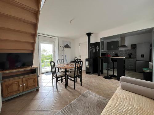 a kitchen and dining room with a table and chairs at Maison campagne in Champ-du-Boult