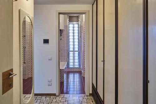 a hallway with a door leading to a bathroom at Villa Lucy - Lake view in Varenna