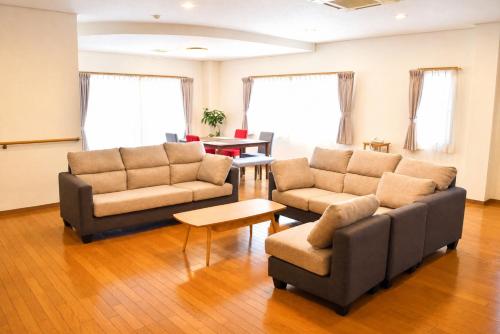 a living room with two couches and a table at Sumomo in Takayama