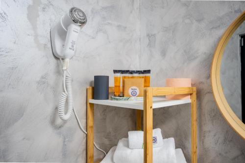 a hair dryer on a shelf next to a mirror at VAMA 25- Vama Veche in Vama Veche